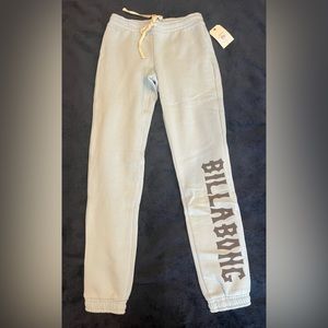 Baby blue sweatpants with billabong text on one leg, adjustable waistband string